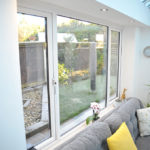 A conservatory in Stapleford, Nottingham with a glass roof, french doors and a vertical radiator