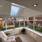A conservatory with a solid roof and french doors in Keyworth Nottingham