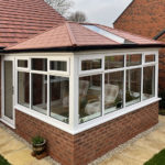 A conservatory with a solid roof and french doors in Keyworth Nottingham