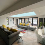 Interior of a home extension with bi-fold door and atrium roof