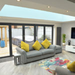 Interior of a home extension with bi-fold door and atrium roof