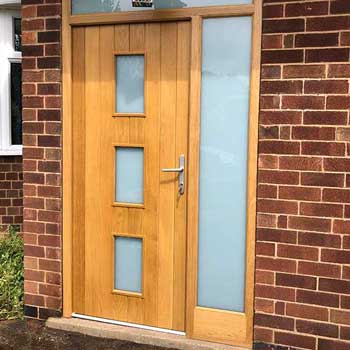 a oak finish hardwood door with opaque glass and side panel from Acorn Windows in Nottingham